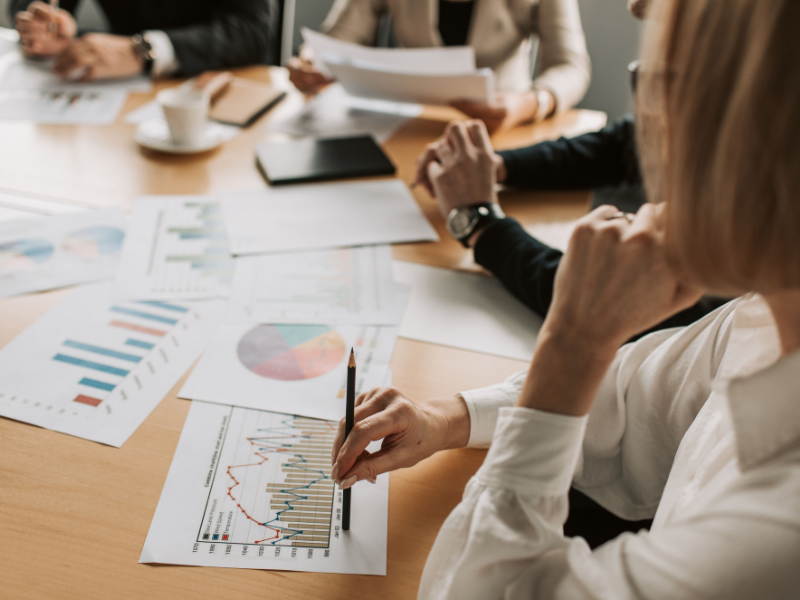 Established business owner reviewing financial reports and Compare bookkeeping packages to determine how much does a bookkeeper cost for your business.